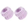 A pair of light purple, fluffy wrist washing bands or cuffs made of absorbent microfiber.