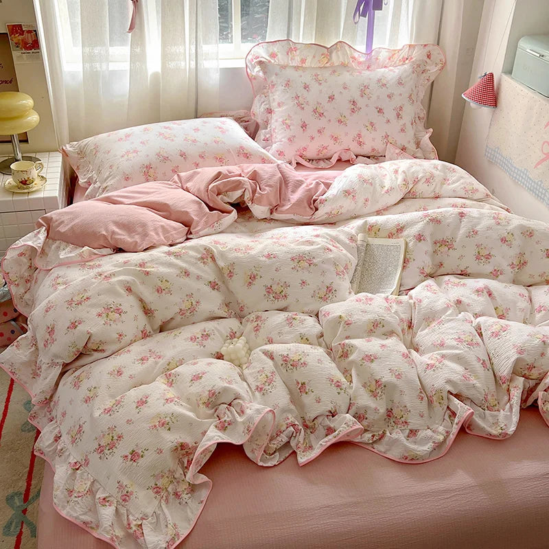 Pink floral duvet cover set with matching pillowcases and flat sheet displayed on a bed.