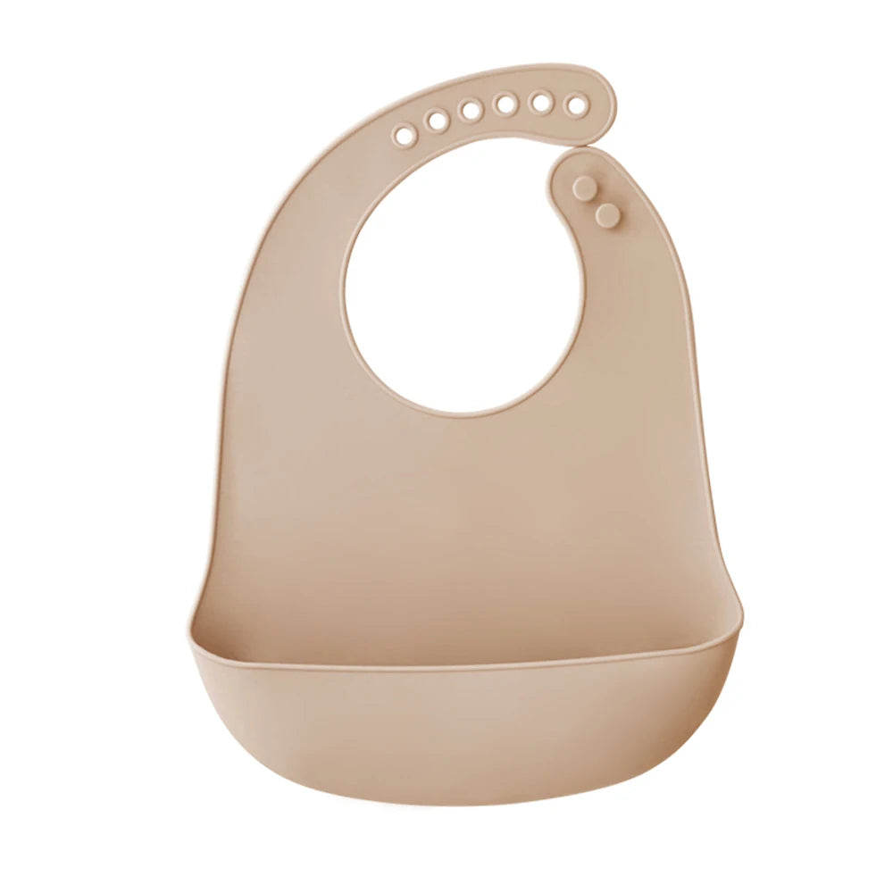 A light beige silicone baby bib with a catch pocket and a curved shape.