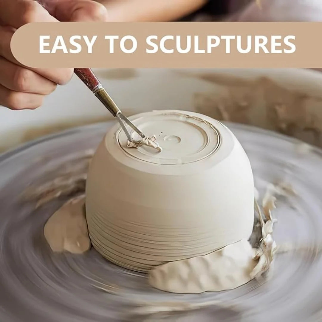 A hand is sculpting a pale beige air-dry clay piece on a gray surface.