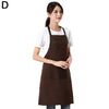 A woman wearing a dark brown waterproof apron with a front pocket.