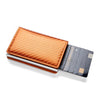 A slim leather card holder with a textured orange-brown cover and a black plastic card slot.