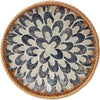 Handcrafted rattan serving tray with mother of pearl inlay featuring a circular, patterned design.