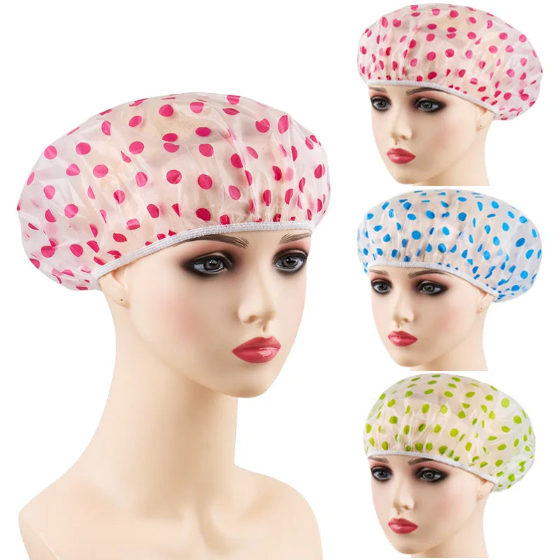 A reusable polka dot waterproof shower cap in pink and white dots shown on a mannequin head.
