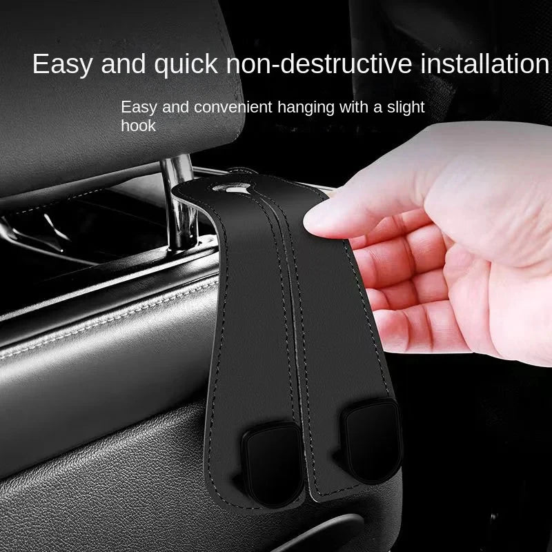 A hand is installing a non-destructive car headrest hook onto a vehicle seat.