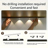 Hands are installing a no drilling LED cabinet light fixture into a surface.
