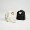 A cream and black embroidered bear stroller organizer bag shown from the side.