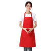 A woman wearing a red waterproof apron over a white shirt.