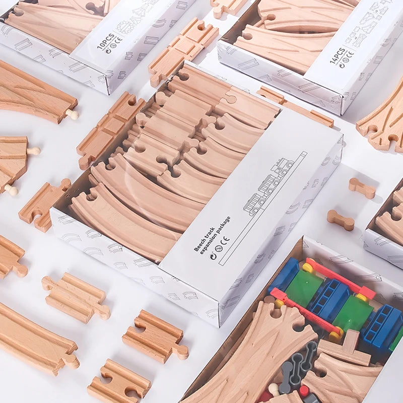 A collection of wooden train track pieces and expansion packs for building trains.