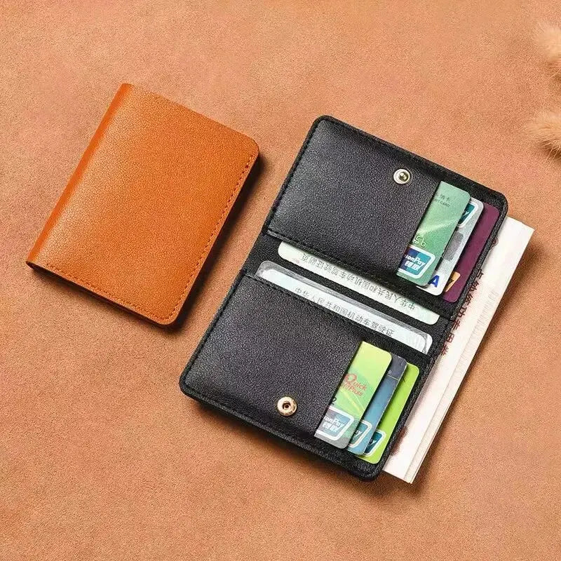 A black ultra-thin PU leather compact wallet with multiple card slots resting on a brown surface.