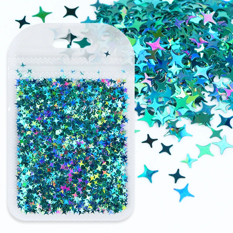 A white plastic pouch filled with iridescent holographic star sequins scattered on a white background.