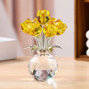 A crystal sculpture featuring a bouquet of yellow and amber reflective roses in a clear glass vase.