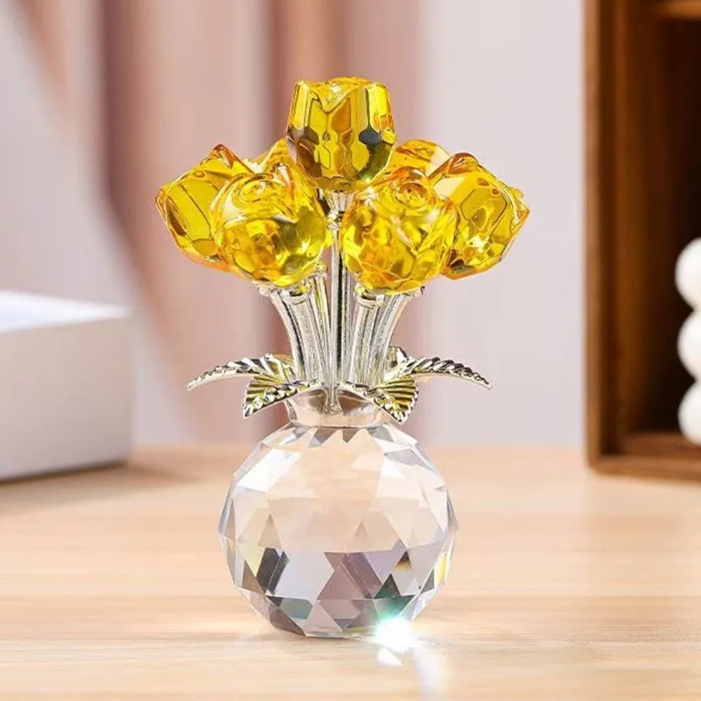 A crystal sculpture featuring a bouquet of yellow and amber reflective roses in a clear glass vase.