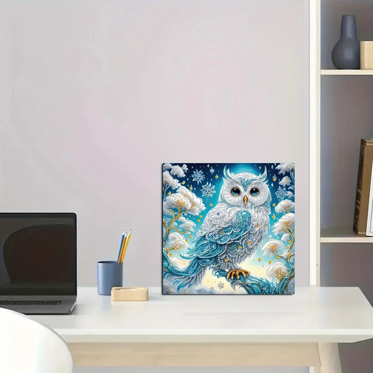 A close-up of a DIY diamond painting kit featuring an owl design with shaped crystals and sparkling blue and white elements.