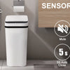 A white motion sensor bathroom trash can next to a toilet, highlighting its features like mute, kick & touch sensor, and auto