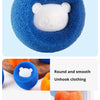 A hand is squeezing a blue laundry ball, demonstrating the cleaning power of reusable pet hair remover balls.