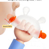 A hand holds a clear silicone bunny-shaped baby teether with an orange handle, demonstrating its size.