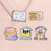 A set of four enamel pins featuring literary quotes and themes like book hoarding social life and book hangover