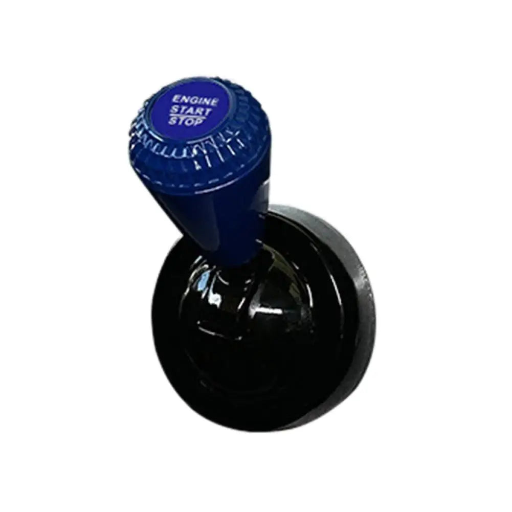 Blue engine start stop button cover with a diamond pattern mounted on a black base.