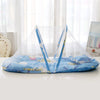 A portable mosquito net for a crib featuring blue fabric, pillows, and a cotton pad.