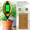 A yellow and black soil testing probe with a digital display measuring pH, temperature, and moisture in a potted plant.