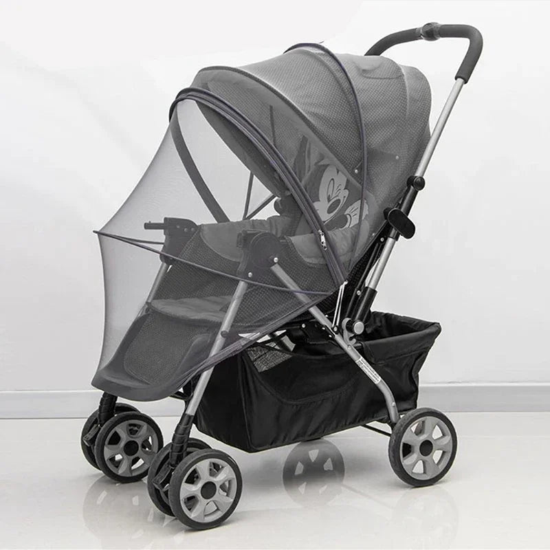 A black universal mosquito net cover for a baby stroller or crib with a handle and wheels.