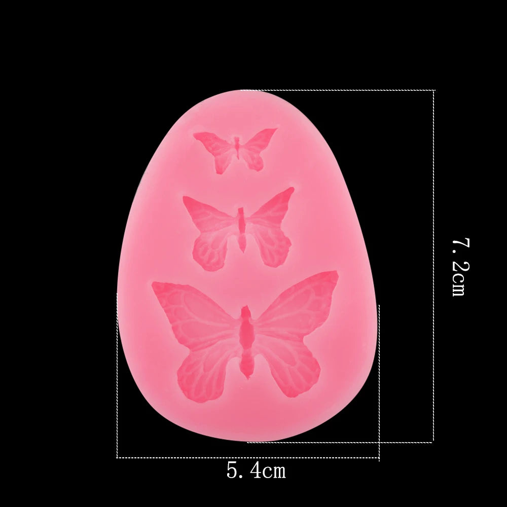 A pink, oval epoxy resin mold shaped like a butterfly for DIY jewelry making.