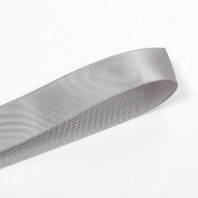 A roll of silver satin ribbon, approximately 25 yards long and wide, shown diagonally.