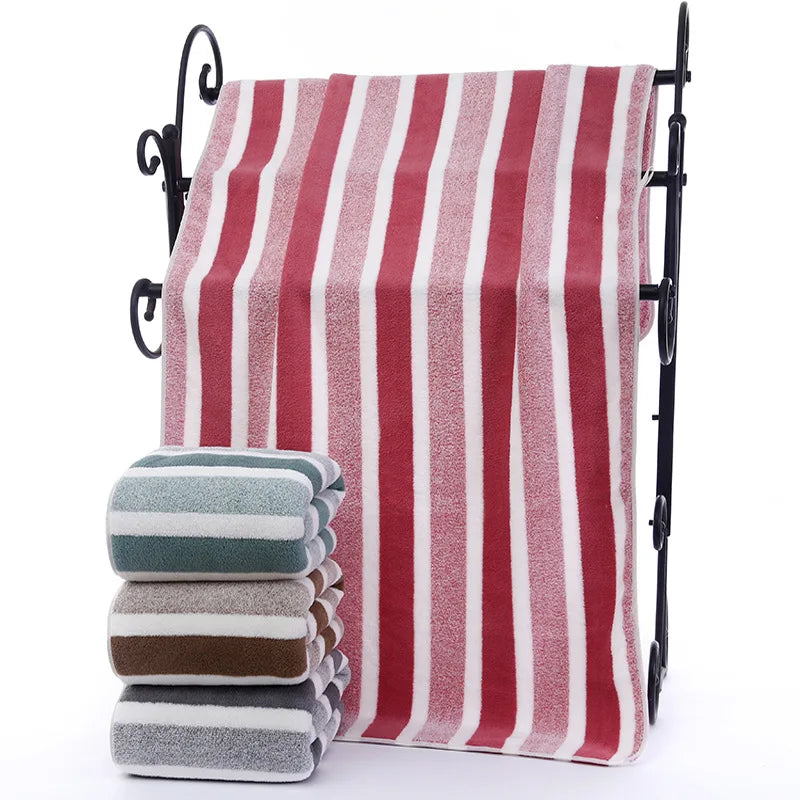 A set of striped microfiber towels hanging on a black rack.