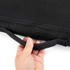 A hand is pulling open a black waterproof paddle board deck bag with a zipper and strap.