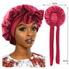 A model wears a silky satin sleep cap with a wide band in a deep rose color, shown alongside the product and its measuring ta