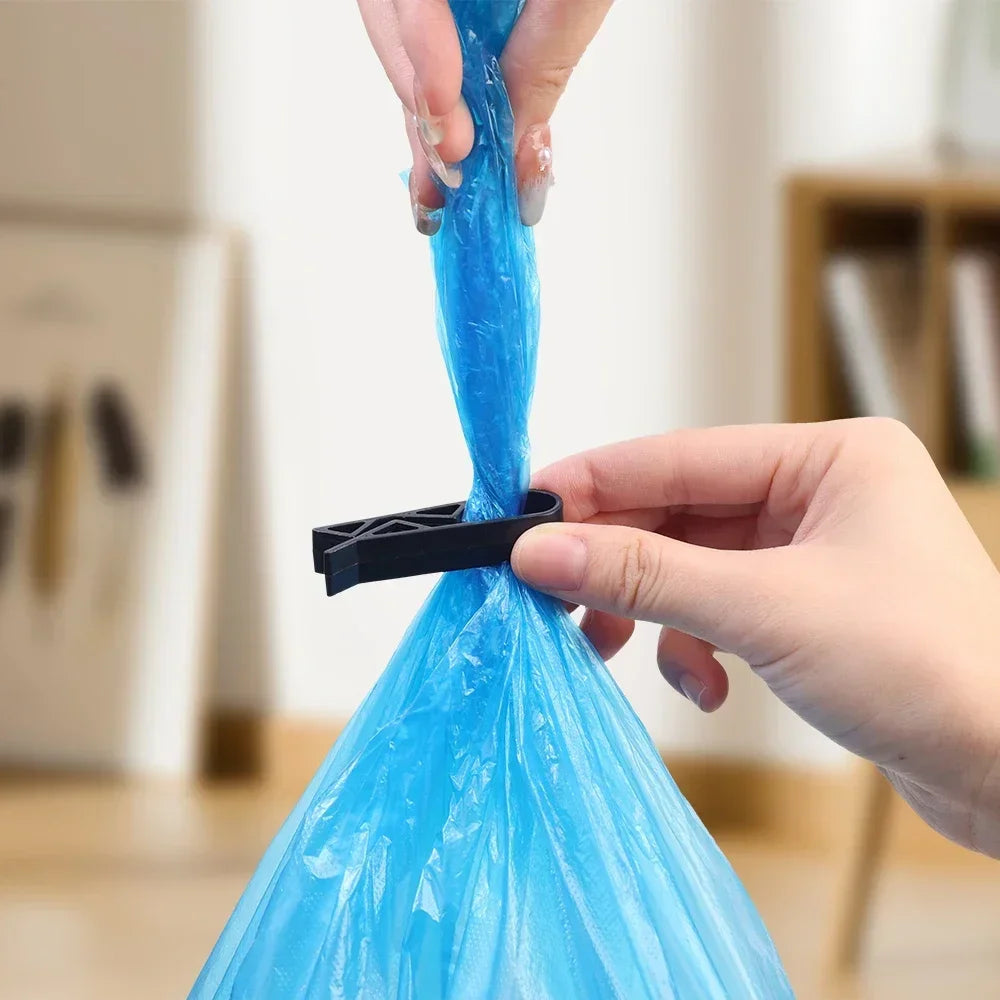 A hand is using a black clip to secure a blue plastic garbage bag or trash bag.