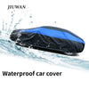 A black and blue waterproof car cover being splashed by water, demonstrating its protection.