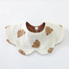 A cream-colored baby feeding bib with a brown bear design and a wooden-look collar.