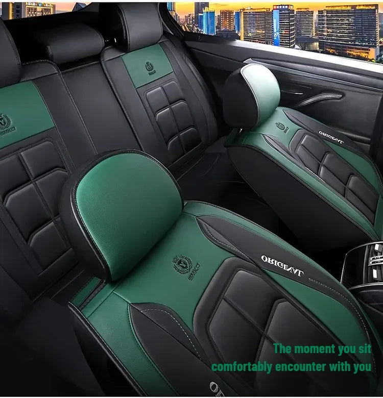 A close-up view of a black car seat cover with green accents and stitching inside a vehicle.