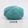 A ball of teal colored 4-ply milk cotton yarn for knitting and crochet.