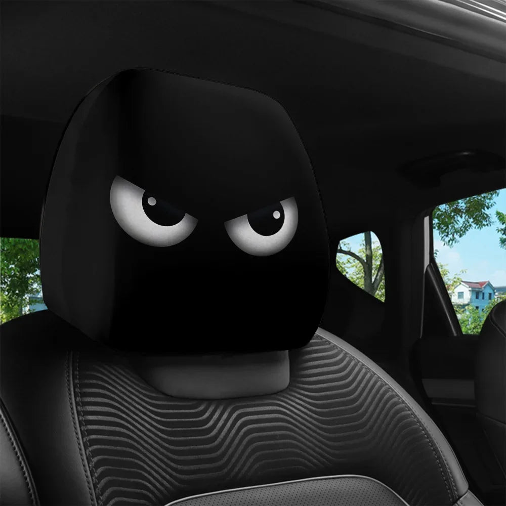 A black car headrest cover with slanted eyes design is visible inside a vehicle.