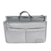 A light gray purse organizer insert with multiple compartments and a fabric strap.