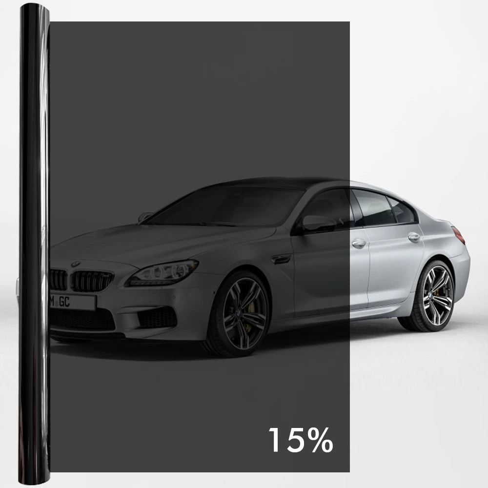 A silver BMW sedan with a dark tint film applied to the windows.