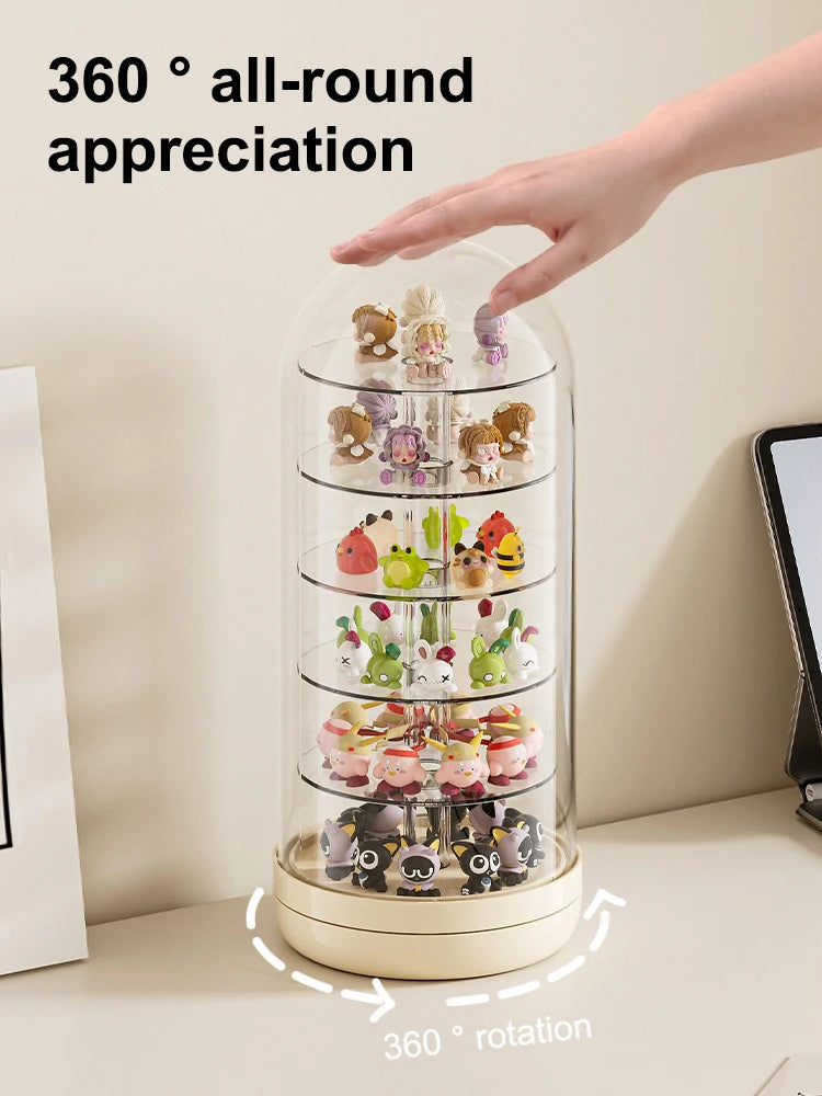 A hand rotates a transparent display case filled with various small collectible figures for 360 degree appreciation.