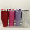 Four 40oz rhinestone bling tumblers in red, pink, purple, and silver with straws and handles.
