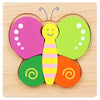 A wooden jigsaw puzzle featuring a bee character with colorful body parts and wings.