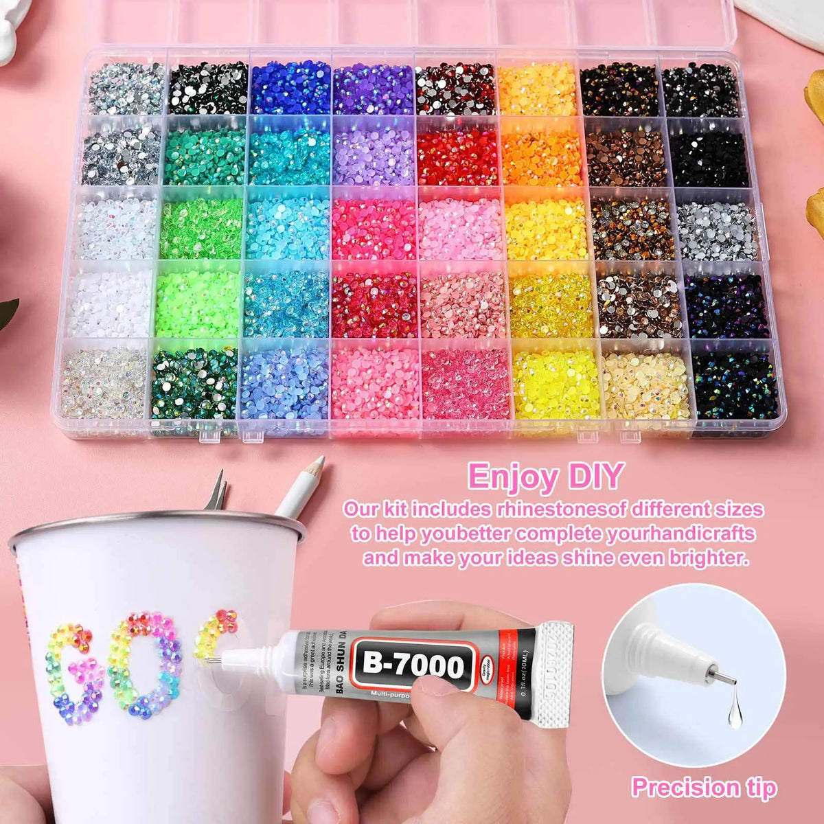 A tray of mixed color acrylic rhinestones is shown next to a bottle of glue and a precision tip for DIY crafts.