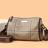A beige vintage genuine leather women's shoulder bag with stitching and a leather strap.
