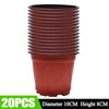 A stack of 20 reusable terracotta-colored plastic seedling pots with ribbed sides.