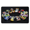 A collection of ten die-cast pull-back cars in various colors and designs arranged in a circle on a black surface.