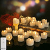 A collection of white LED tea light candles arranged on a wooden surface with a remote control visible nearby.