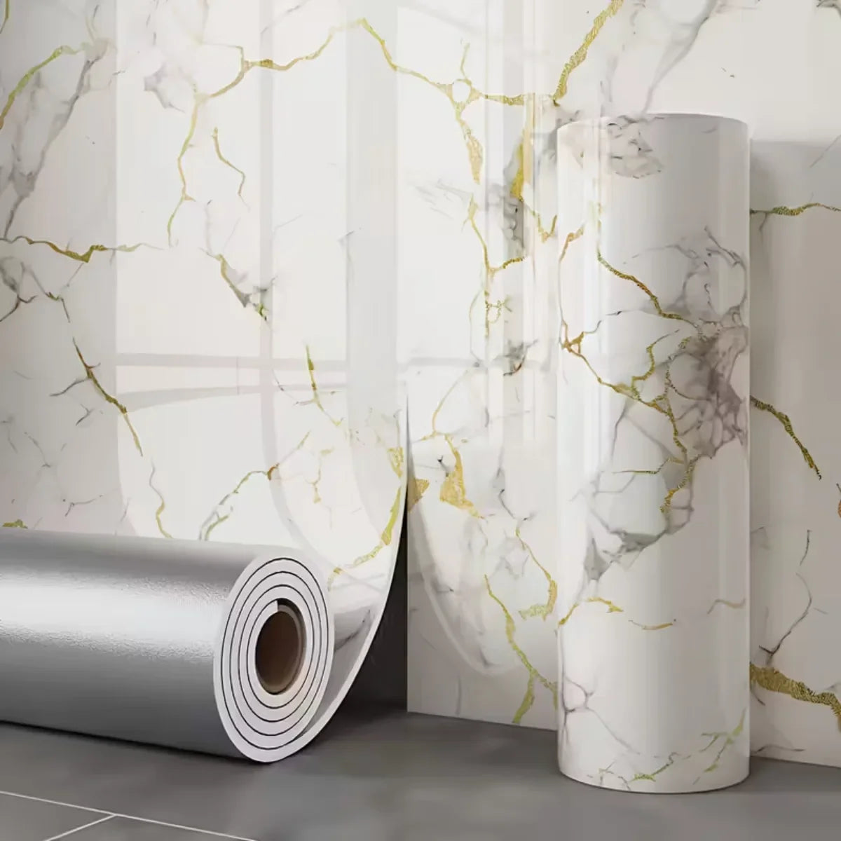 Roll of silver 3D marble peel-and-stick waterproof wall panels against a white marble background.