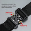 Close-up of a black tactical nylon belt and buckle showing instructions for pressing the mechanism.