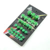 A set of thirty decorative green motorcycle screw cap covers arranged in rows on a black card.